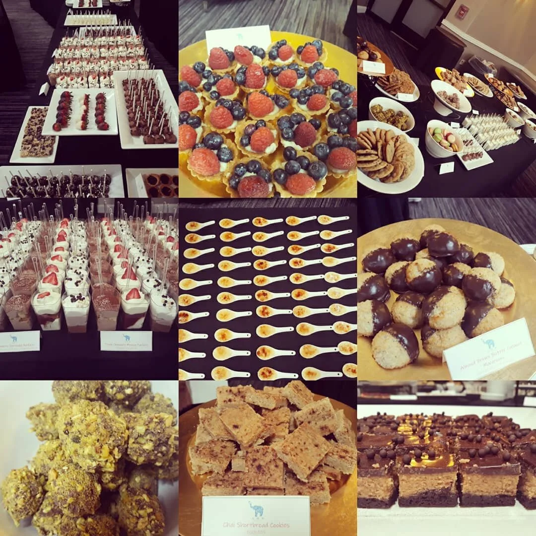 Elegant dessert table display with tiered stands and assorted petit fours